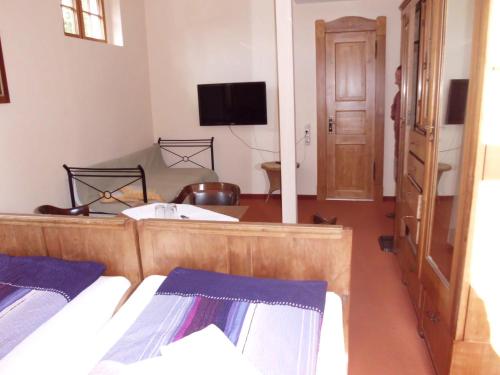 a bedroom with two beds and a flat screen tv at Haus Nixe in Loddin