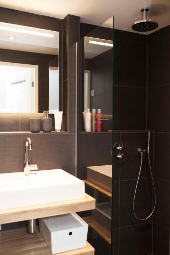 a bathroom with a sink and a mirror at hip & stylish apartment in center, near trainstation, 15 min walk in Amsterdam