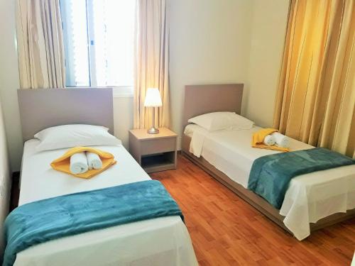 a bedroom with two beds with towels on them at 16 SANDY BEACH in Larnaca