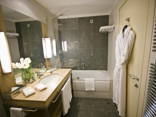 a bathroom with a sink and a bath tub at Mirage Hotel in Kazan