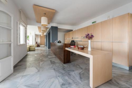 a kitchen with a wooden floor and hard wood flooring at Far Out Hotel & Spa in Mylopotas