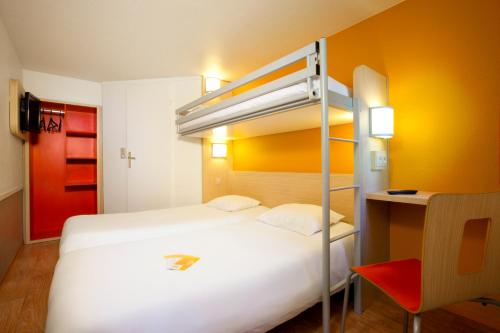 a bedroom with a bunk bed and a desk at Premiere Classe Toulouse Sesquières in Toulouse
