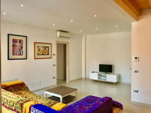 a living room with a couch and a tv at Palazzo Penzo Bellemo in Chioggia