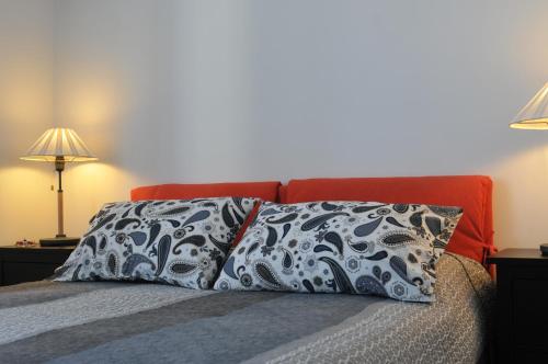 a bedroom with a bed with two pillows on it at Sea Apartment in Sanremo
