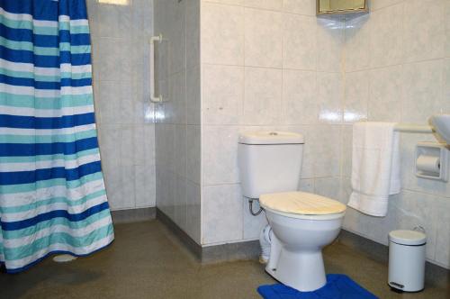 a bathroom with a toilet and a sink at Gorsnavoon Cottage in Clachaig