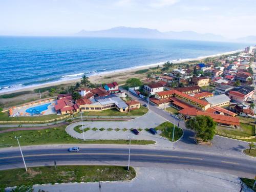 an aerial view of a town next to the ocean at Hotel Águas Vivas in Caraguatatuba