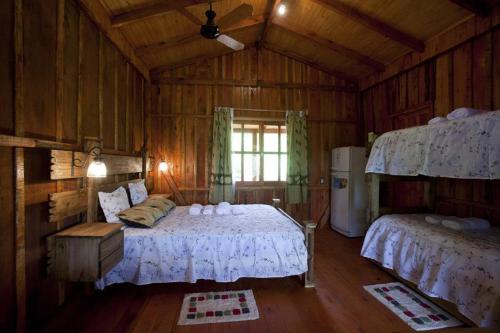 a bedroom with a bed in a wooden room at Aires del Monte in El Soberbio