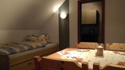 a living room with a bed and a table with a table sidx sidx at Haus Schnorbus in Hallenberg