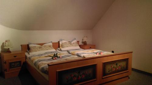 a bedroom with a large bed with flowers on it at Haus Schnorbus in Hallenberg