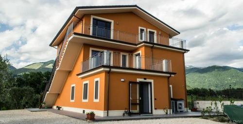 a large orange house with a balcony at Santa Giusta in Picinisco