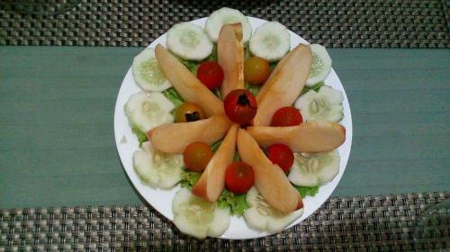 a plate of fruit and vegetables on a table at Abeth's Haven in Puerto Princesa City