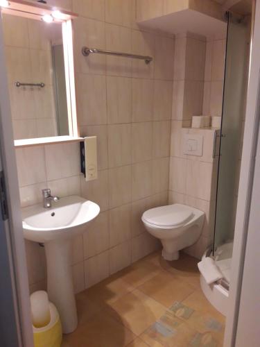 a bathroom with a sink and a toilet at Hotel Paola in Kutno