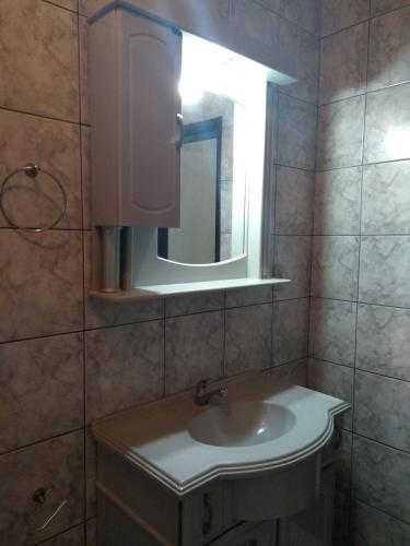 a bathroom with a sink and a mirror at Apart São Gabriel in São Gabriel