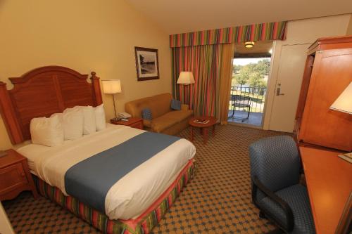a hotel room with a bed and a chair at Kentucky Dam Village State Resort Park in Gilbertsville