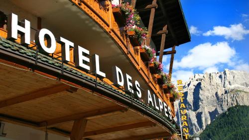 a hotel sign on the side of a building at Hotel Des Alpes in Selva di Val Gardena