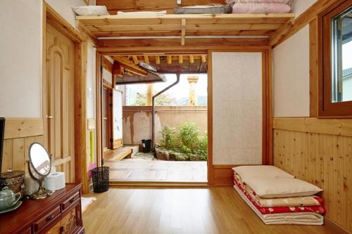 a room with a large room with a large window and a bed at Nadle Bang in Jeonju