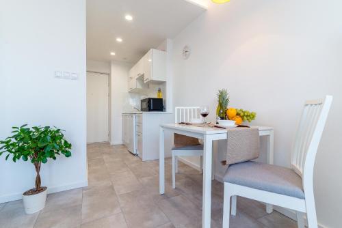 a kitchen and dining room with a table and chairs at Rent like home - Bagno 7 in Warsaw