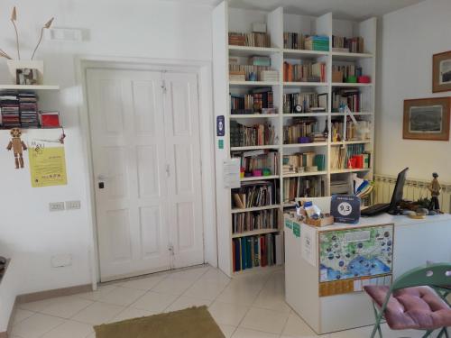 a room with a refrigerator and a book shelf with books at B&B Villa Ada in Formia
