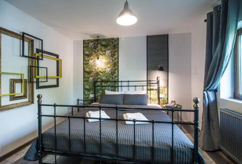 a bedroom with a bed with a black metal frame at Rent in Cluj Apartments in Cluj-Napoca