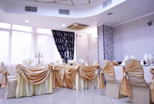 a room with two tables with chairs and a table cloth at Pensiunea Nicolas in Craiova