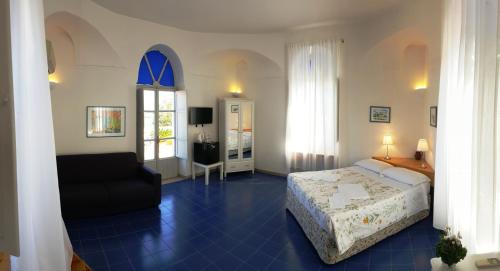 a bedroom with a bed and a chair in a room at Farmstay La Morella in Battipaglia