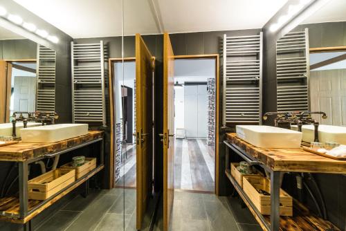 a bathroom with two sinks and two mirrors at Rent in Cluj Apartments in Cluj-Napoca