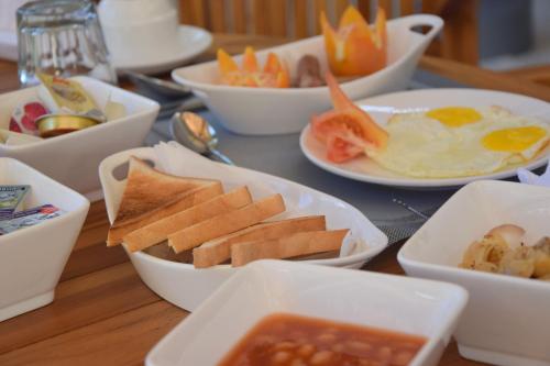 a table with bowls of food on a table at Araamu Hotels Maldives at Dhiffushi in Dhiffushi