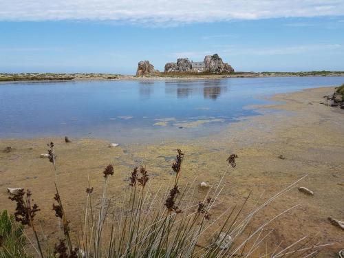 a large body of water with rocks in the background at Parc an Porz in Lannion