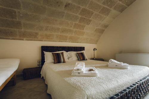 a bedroom with a large bed with towels on it at Casastella in Matera