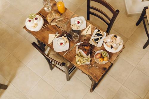 a wooden table with plates of food on it at Casastella in Matera
