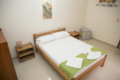 ein Schlafzimmer mit einem Bett mit zwei Handtüchern darauf in der Unterkunft Hotel La Esperanza 2 in Leticia
