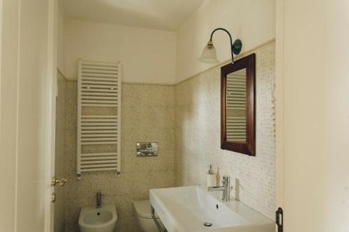 a bathroom with a sink and a toilet at Casastella in Matera