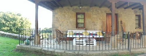 a stone house with a fence in front of it at Amets etxalde in Santecilla
