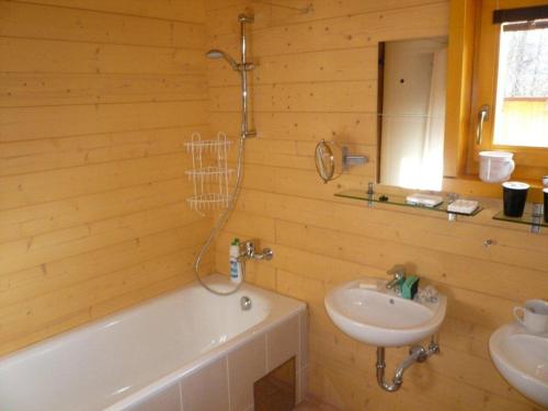 a wooden bathroom with a sink and a tub and a sink at Chalets under Falcon Ridge in Česká Ves