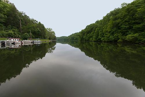 a river with boats parked on the side of it at Greenbo Lake State Resort Park in Argillite