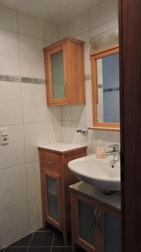 a bathroom with a sink and a mirror at Ferienwohnung Am Homburg Nr 3 in Saarbrücken