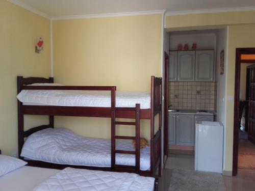 two bunk beds in a room with a kitchen at Apartments Sandra in Tivat