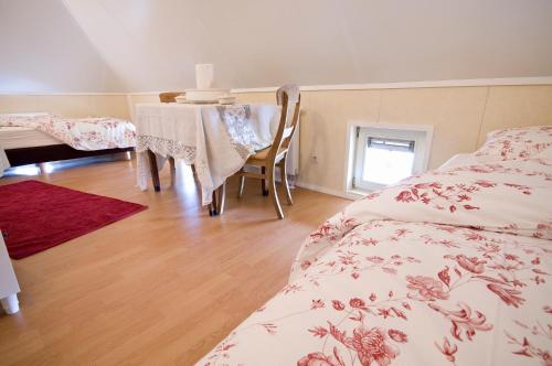 a bedroom with a bed and a table with a dining room at Erve Woolderink in Wierden