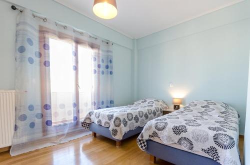 A bed or beds in a room at Leo - Unique Glyfada Apartment