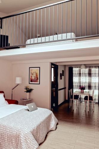 a bedroom with a large bed and a staircase at Appartamenti Borghetto Panigale in Bologna