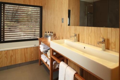 y baño con lavabo y espejo. en Las Majadas Hotel & Centro de Reuniones, en Pirque