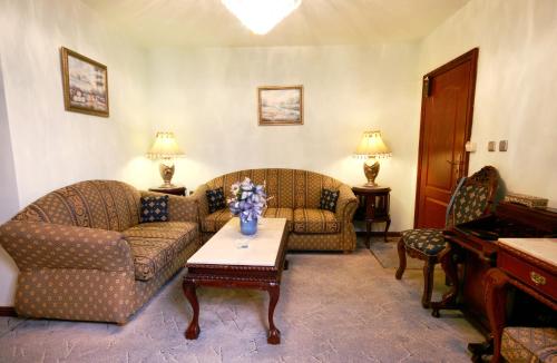 a living room with two couches and a piano at Dallas Residence in Varna City