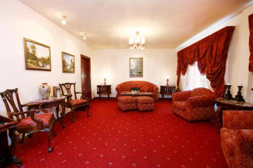 a living room with a couch and chairs at Dallas Residence in Varna City