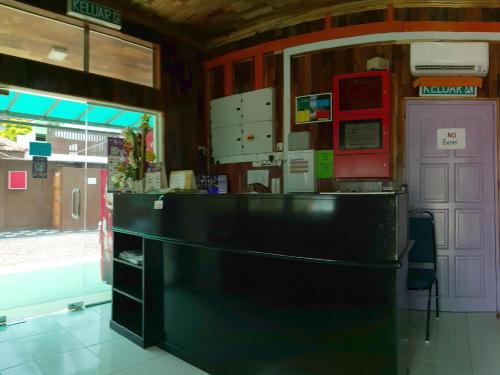 a kitchen with a black counter in a room at Mabohai Resort Klebang in Melaka