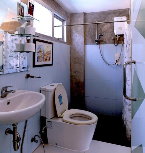 a bathroom with a toilet and a sink at Phuket Paradiso in Chalong 