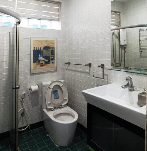 a bathroom with a toilet and a sink at Phuket Paradiso in Chalong 