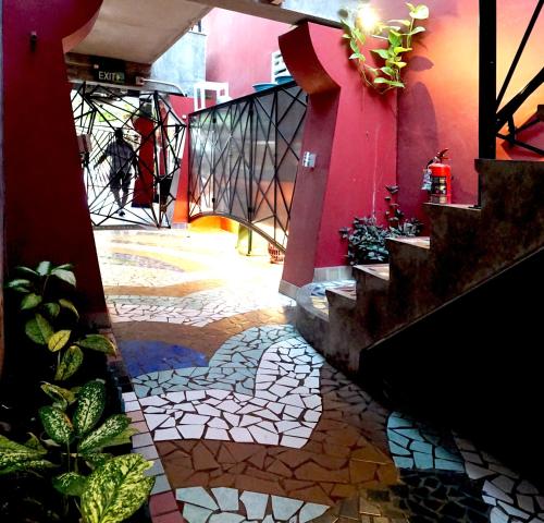 a stairway with a tile floor and a red wall at Phuket Paradiso in Chalong 