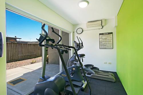 a gym with two treadmills on a treadmill at Mantra Nelson Bay in Nelson Bay