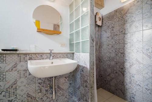 a bathroom with a sink and a shower at Villa Na Pran, Pool Villa in Pran Buri