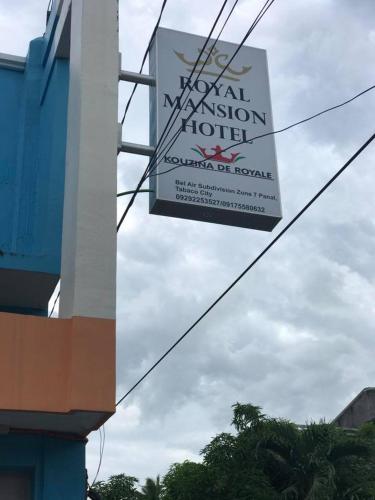 a sign for a hotel on the side of a building at Royal Mansion Hotel in Tabaco